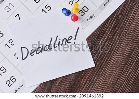 Deadline concept. A paper with Deadline text pinned on monthly calendar. White card with Deadline text pinned with push pins on calendar date. Last day, Last chance concepts