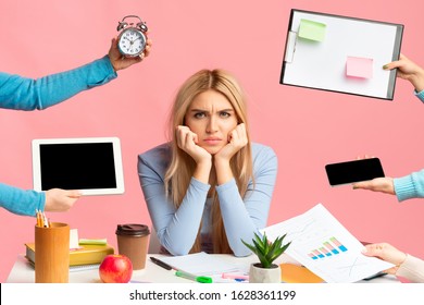 Deadline And Multitask. Tired sad girl stressed by a lot of work, sitting at desk, looking angrily at camera, mock up - Shutterstock ID 1628361199