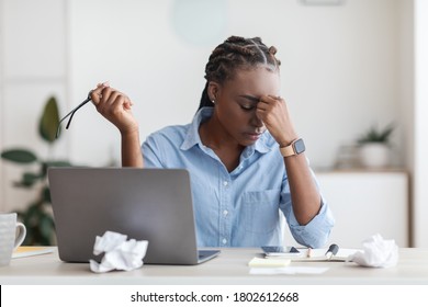 Deadline Stress. Overworked Black Female Entrepreneur Massaging Nosebridge At Workplace In Office, Exhausted After Using Laptop - Shutterstock ID 1802612668