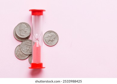 Deadline and time is money concept with hourglass and US coins currency. sand clock time for saving concept. - Powered by Shutterstock