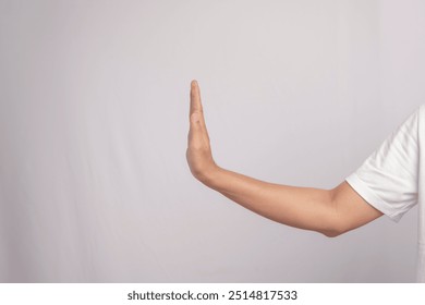 Deaf gesture "Stop or refuse" with hands. "Stop or refuse" gesture in sign language, isolated on white background. The person's hand is raised upwards to form the word "Stop or reject". - Powered by Shutterstock