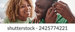 deaf and happy african american man wearing hearing aid near girlfriend, health device banner