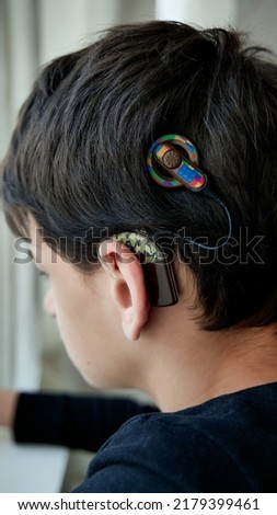 Deaf teenager with cochlear implant, Speech processor stickers