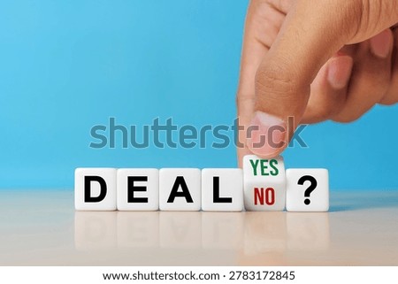 Deal or no deal? Hand turns a cube and changes the word 