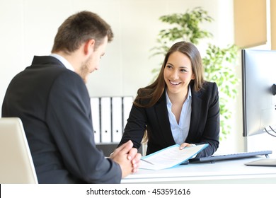 Dealer attending to a customer in a desktop in the office