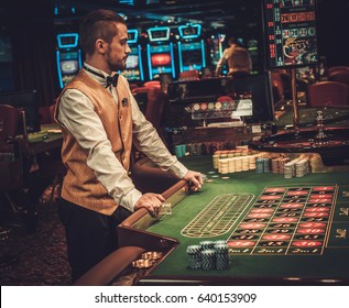 Dealer Behind Table In A Casino