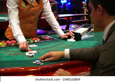 Dealer puts down a card on blackjack table