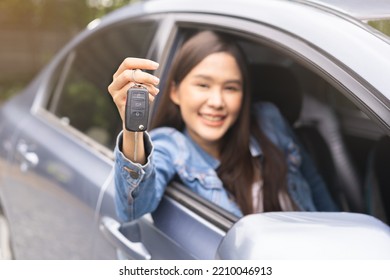 Dealership Automobile, Smile Asian Young Woman, Happy Girl Sitting In New Car After Purchase Success, Showing, Holding Auto Remote Key Of Vehicle, Owner Driver Female Buy Gift For Yourself At Showroom