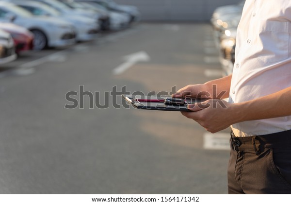 Dealership manager. Car rent agent manager holding\
clipboard and key of new\
car
