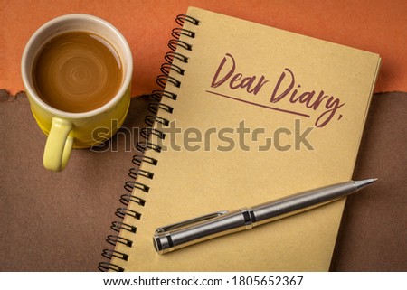 Dear Diary - handwriting in a spiral sketchbbok with a cup of coffee, jouranling concept