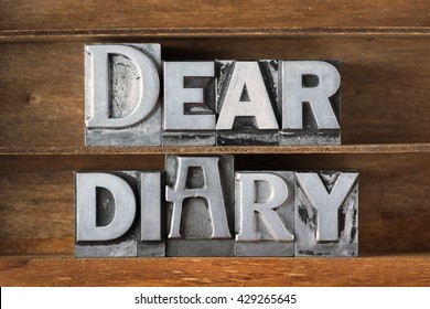 Dear Diary Phrase Made From Metallic Letterpress Type On Wooden Tray
