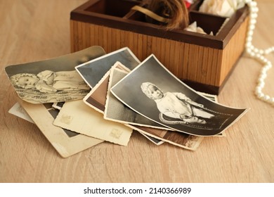 dear to heart memorabilia in an old wooden box, stack of retro photos, vintage photographs of 1940, concept of family tree, genealogy, childhood memories, home archive