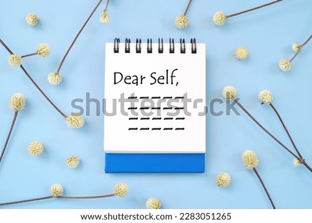 Dear self, personal reflection and advice to self concept. Flat lay journal diary in blue background.