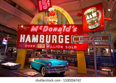 Dearborn, MI / USA - 04.22.2018: Old  Blue Chevrolet Bel Air Car With Colorful Mcdonalds Neon Advertisement