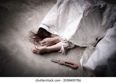 Death of asian woman by suicide with slit her wrist, dead body woman was cover by white sack with suicide evidence.