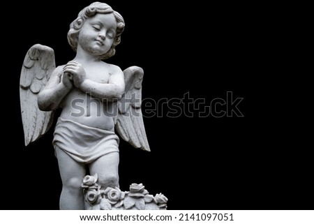 Death concept. Little beautiful angel crying as symbol of pain, fear and end of human life. Fragment of an ancient statue isolated on black background. Copy space.