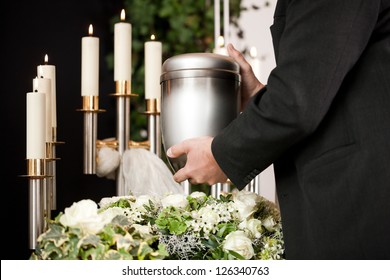 Death And Dolor  - Funeral And Cemetery, Mortician Carrying The Urn To A Bed Of White Roses