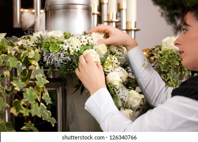 Death And Dolor  - Mortician On Funeral With Urn Preparing The Flowers