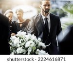 Death, funeral and carry coffin with family mourning, sad and depressed for grieving time. Grief together, mental health and man holding casket for church service, memorial and difficult for loss.