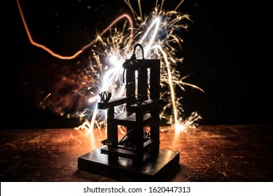 Death penalty electric chair miniature on dark. Creative artwork decoration. Image of an electric chair scale model on a dark backgorund