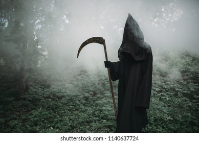 Death with a scythe in the dark misty forest