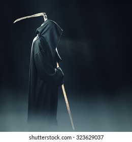 Death With Scythe Standing In The Fog At Night