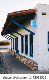 Death Valley Junction, California - March 30 2019: In The Desert, The Remnants Of A Building With A Payphone Sign. It Reads 