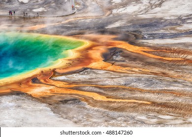 Deatiled photo of Grand Prismatic Spring from above with unrecognizable tourists watching it. Yellowstone National Park, Wyoming, USA - Powered by Shutterstock