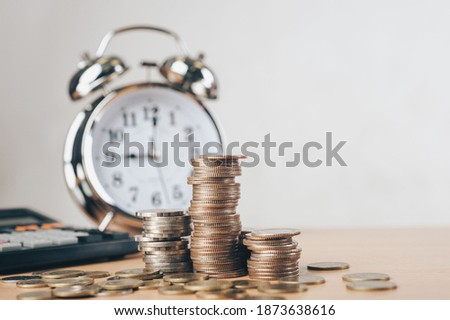 debt collection and tax season concept with deadline remind note, coins, banks, calculator on table, background, time to pay concept. Business and Pay tax concept.