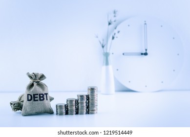 Debt Financing  Bad, Unsecured Consumer Debt, Financial Concept : Debt Bags, Stacks Of Coins On A Table, Depicts Rising In Total Interest Expense A Borrower Should Repay To A Lender When Paying Late
