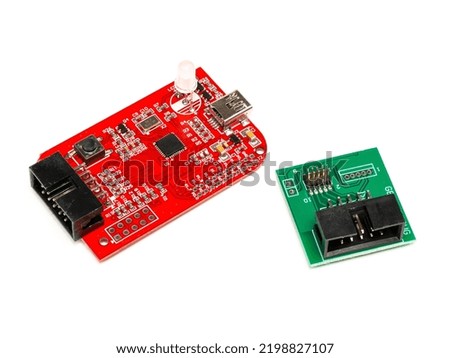 Debugger flasher board with a usb port for program chips and memory, with green adapter. Isolated on a white background.