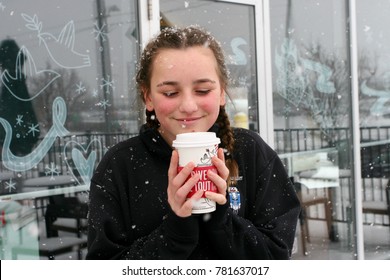 Dec 15th, 2017- Ontario, Canada: Young Teenage Girl Enjoying A Starbucks Holiday Drink Outside In The Snow