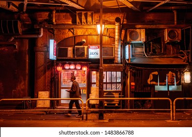 DEC 4, 2018 Tokyo, Japan - Izakaya Bar And Night Street Restaurant With Neon Signs And Local People Walking On Small Street Near Kanda JR Station