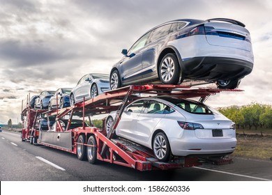 Dec 8, 2019 Bakersfield / CA / USA - Car Transporter Carries New Tesla Vehicles Along The Interstate To South California, Back View Of The Trailer