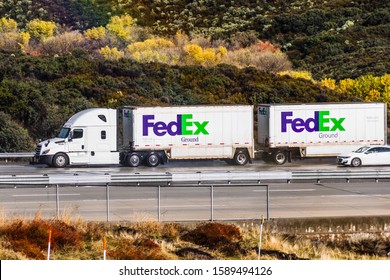 Dec 8, 2019 Los Angeles County / CA / USA - Side View Of FedEx Ground Truck Towing Two Trailers Driving On The Interstate