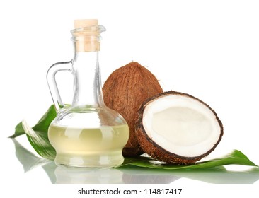 decanter with coconut oil and coconuts isolated on white