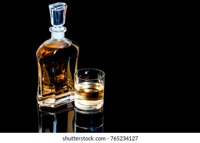 Decanter And A Glass Of Whiskey On A Black Background