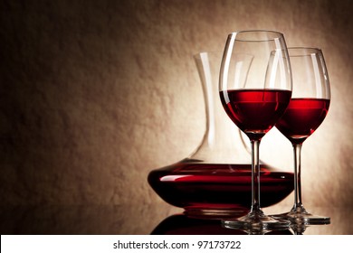 Decanter With Red Wine And Glass On A Old Stone Background