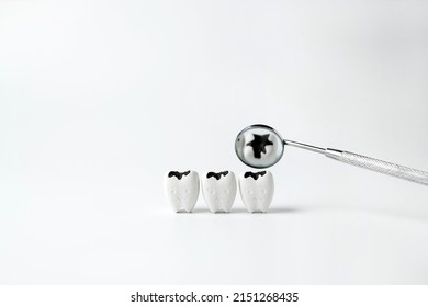  Decay tooth with black cavity reflect on mirror mouth on white background, checkups with dentist quickly                                                 