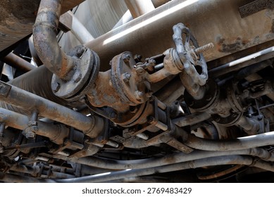 Decayed And Tangled Piping System Beneath Industrial Facilities With Corroded Valves And Complex Connectors