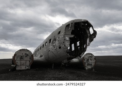 A decaying aircraft wreckage set against a desolate, overcast landscape, evoking a sense of abandonment and history. - Powered by Shutterstock