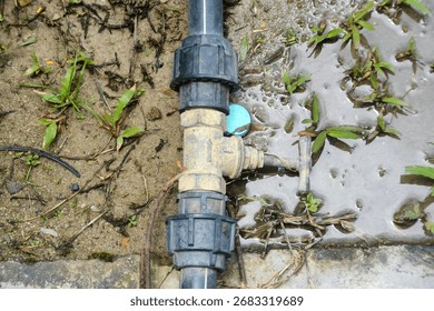 a decaying pipe fitting, held by old rusty wires, serves as a powerful visual metaphor for aging water systems and potential infrastructure failure.