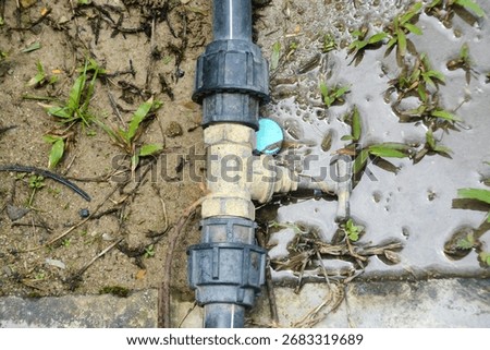 a decaying pipe fitting, held by old rusty wires, serves as a powerful visual metaphor for aging water systems and potential infrastructure failure.