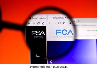 December 19, 2019, Brazil. In this photo illustration the homepage of the Fiat Chrysler Automobiles and Groupe PSA websites is seen displayed on a computer screen through a magnifying glass.