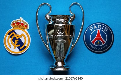 December 19, 2021 St. Petersburg, Russia. The emblems of the football clubs of the 18 finals of the UEFA Champions League Paris Saint-Germain F.C. and Real Madrid CF and a cup on a blue background.