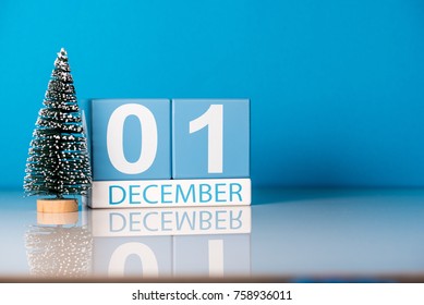 December 1st. Day 1 of december month, calendar with little christmas tree on blue background. Winter time. Empty space for text. New year concept