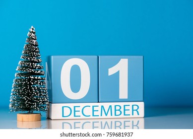 December 1st. Day 1 of december month, calendar with little christmas tree on blue background. Winter time. New year concept