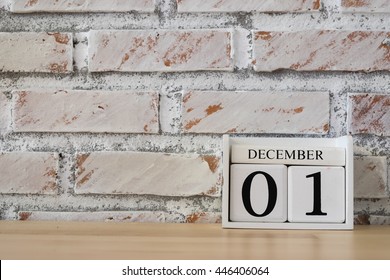 December 1st. Image of december 1 wooden color calendar on white brick wall background. empty space for text. 