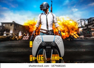 December 20, 2020, Odessa, Ukraine. White new Playstation 5 gamepad on the background of the game PUBG. PLAYERUNKNOWN'S BATTLEGROUNDS cybersport poster concept.