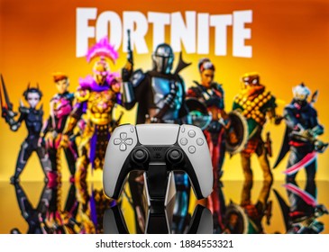 December 20, 2020, Odessa, Ukraine. White new Playstation 5 gamepad on the background of the game fortnite. Fortnite cybersport poster concept.